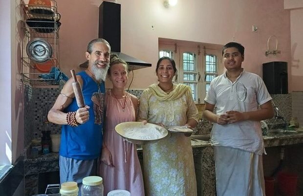 Guests learning to prepare Indian food during a cooking class at Om Homestay in Rishikesh
